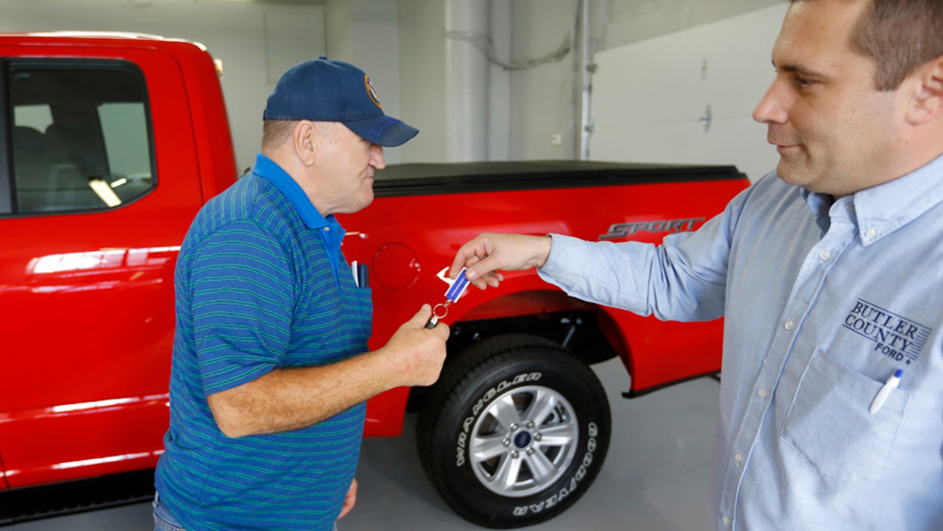 In this Thursday, Nov. 19, 2015, photo, Alton John, left, from Kittanning, Pa., gets the keys to his new 2015 Ford F-150 Supercab 4x4 pickup truck from salesman Robert Myers as he takes delivery at Butler County Ford in Butler, Pa. Haggling over a car price isnt for everyone. The angst has spawned a small but growing trend toward no-haggle alternatives found at discount club stores, some dealers and on several Internet sites. (AP Photo/Keith Srakocic)