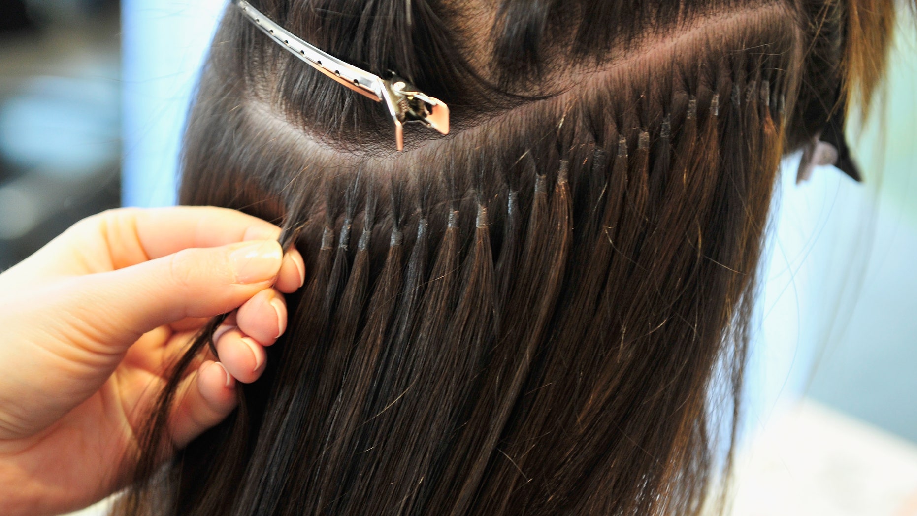MUNICH, GERMANY - JANUARY 10: A hair stylist fixes extensions to the hair of Model Marie Nasemann during a hair dressing session where Nasemann gets hair extensions on January 10, 2014 in Munich, Germany. (Photo by Lennart Preiss/Getty Images)