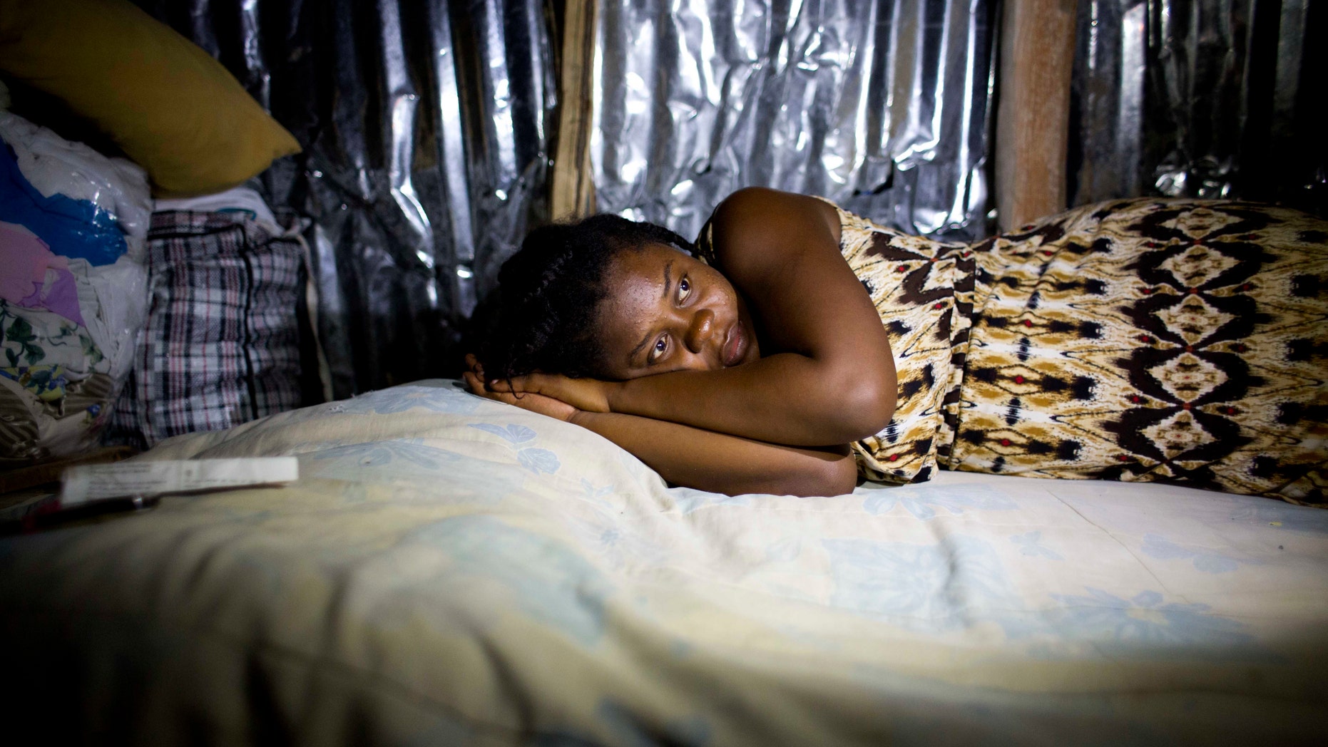 In this Oct. 31, 2016 photo, Nathanaelle Bernard, who is 7 months pregnant, rests on a bed in the shack her uncle built from scavenged materials after the family's home was destroyed by Hurricane Matthew, in Coteaux, Haiti. "I always had this dream my child wouldn't want for anything," the 19-year-old said. After a pause, she added: "It was a nice dream." (AP Photo/Dieu Nalio Chery)