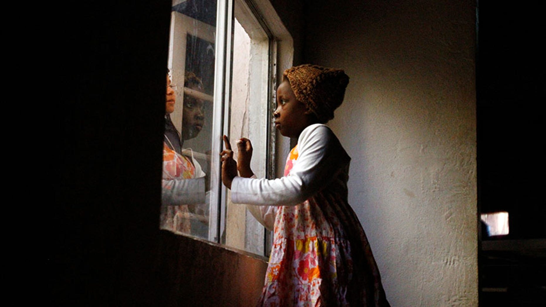 Haitian migrants talk through a window at an Evangelical Church, being used as a shelter for stranded immigrants on their way to the U.S., in Tijuana, Mexico, February 12, 2017.