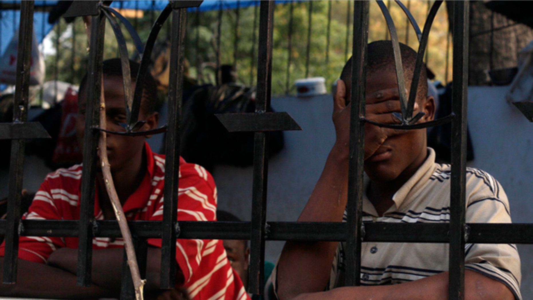 Prisoners are seen at a temporary prison at a street corner in Port-au-Prince, Haiti.