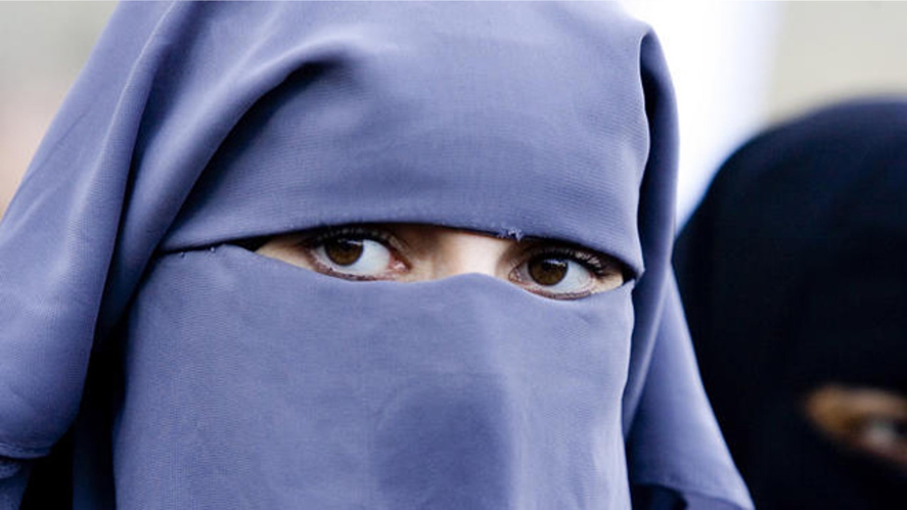 Unidentified women wearing a niqab during a demonstration of about two dozen Muslim women outside the Dutch parliament against a proposed ban on the burqa, the head-to-toe Islamic robe, in The Hague, Netherlands, Thursday, Nov. 30, 2006. Several protesters wore long robes and veils exposing only their eyes, known as a niqab. "We live in a free country and the government cannot tell us what to do with our religion," protest organizer Ayse Bayrak told The Associated Press. Hard line Immigration Minister Rita Verdonk is drawing up legislation banning the burqa and other clothes that cover the face in public places. (AP Photo/ Fred Ernst)