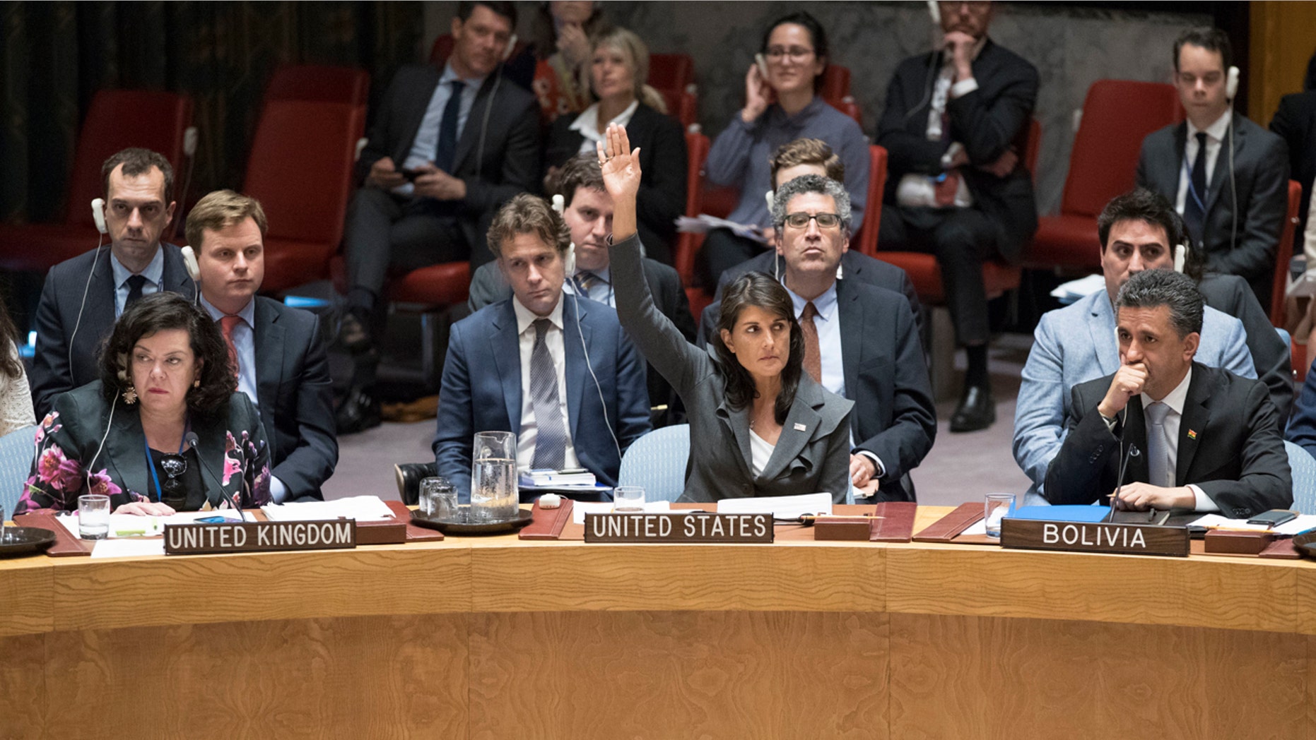 U.S. Ambassador to the United Nations Nikki Haley, center, votes in favor of a resolution introduced by the United States during a Security Council meeting on the situation between the Israelis and the Palestinians, Friday, June 1, 2018 at United Nations headquarters.