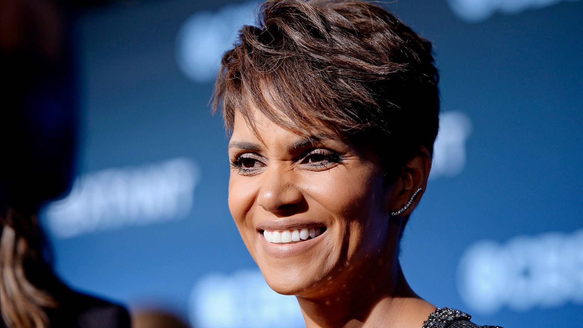 June 16, 2014. Cast member Halle Berry of the CBS science fiction television series "Extant," smiles during an interview at the premiere of the series at the Samuel Oschin Space Shuttle Endeavour Display Pavilion in Los Angeles, California.