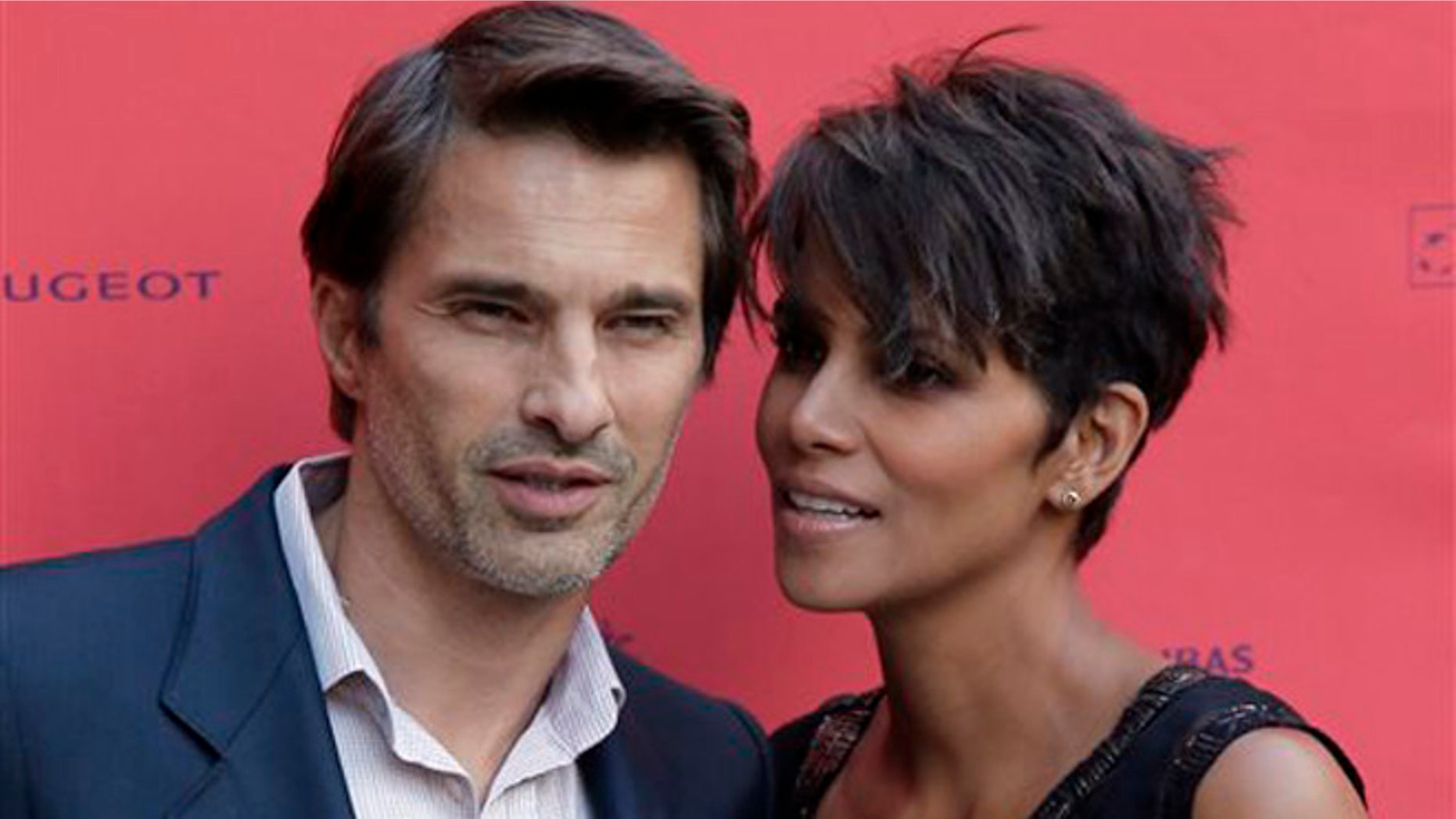 FILE - In this June 13, 2013 file photo, actor and president of the Champs-Elysees Film Festival Olivier Martinez, left, poses with Actress Halle Berry prior to the screening of the film "Things We Lost in the Fire" with the french title "Nos Souvenirs Brules" during the Champs-Elysees Film Festival, at the "Publicis Cinema" in Paris. Berry and Martinez are ending their two-year marriage. The couple released a joint statement Tuesday, Oct. 27, 2015, saying they plan to divorce. (AP Photo/Francois Mori, File)
