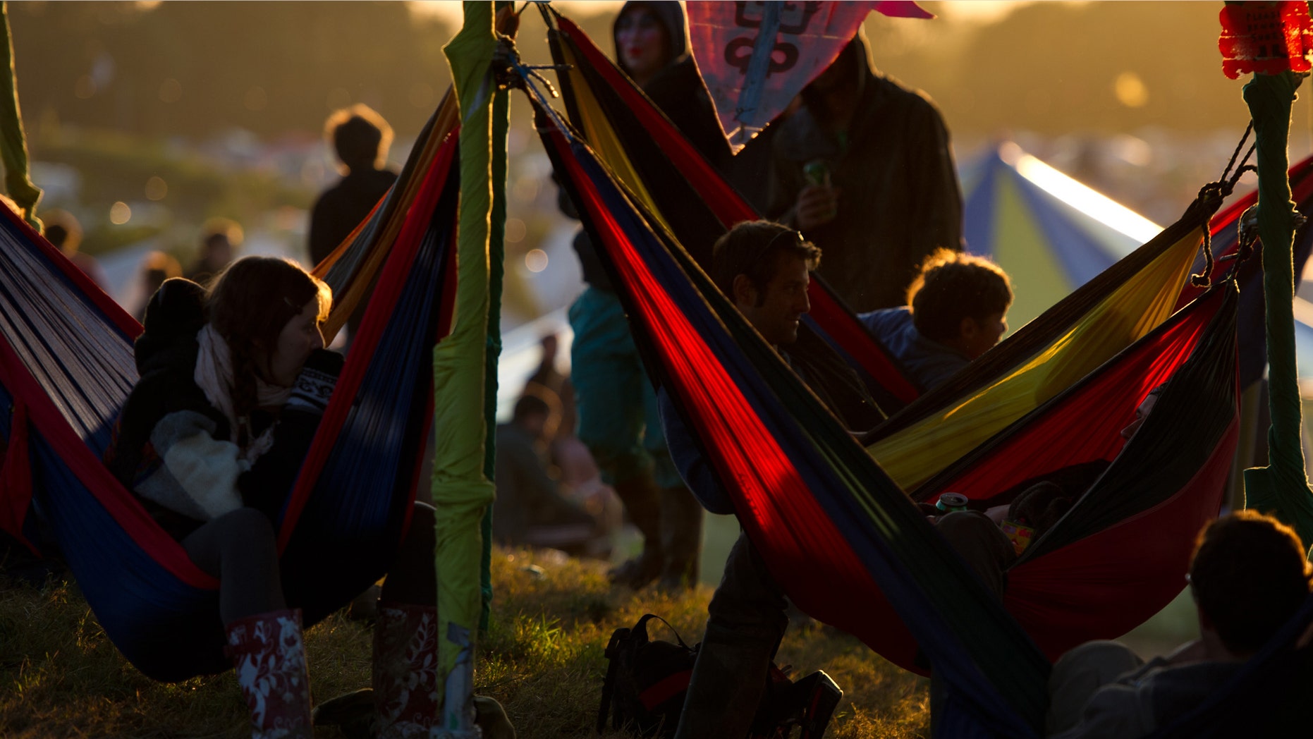 GLASTONBURY, ENGLAND - JUNE 23: Festival goers relax in hammocks during the Glastonbury Festival at Worthy Farm, Pilton on June 23, 2011 in Glastonbury, England. The festival, which started in 1970 when several hundred hippies paid 1 GBP to watch Marc Bolan, has grown into Europe's largest music festival attracting more than 175,000 people over five days (Photo by Ian Gavan/Getty Images)