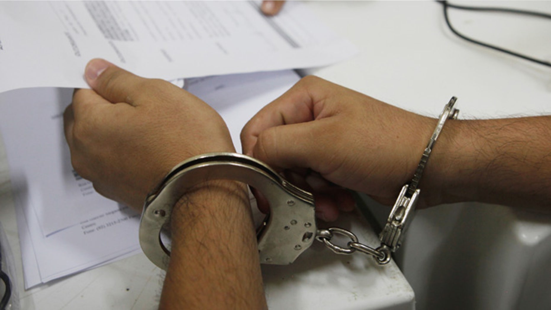 MANAUS, BRAZIL - FEBRUARY 18: A handcuffed inmate meets with an attorney to update his case in the overcrowded Puraquequara prison on February 18, 2016 in Manaus, Brazil. The prison holds nearly 1,400 inmates, around twice as many as it was designed for. Brazil now holds the fourth-largest prison population in the world, behind the U.S., Russia and China, with the number of Brazilians behind bars nearly doubling in the past decade. The prison system currently holds more than 600,000 inmates, 61 percent over capacity, according to Human Rights Watch. (Photo by Mario Tama/Getty Images)