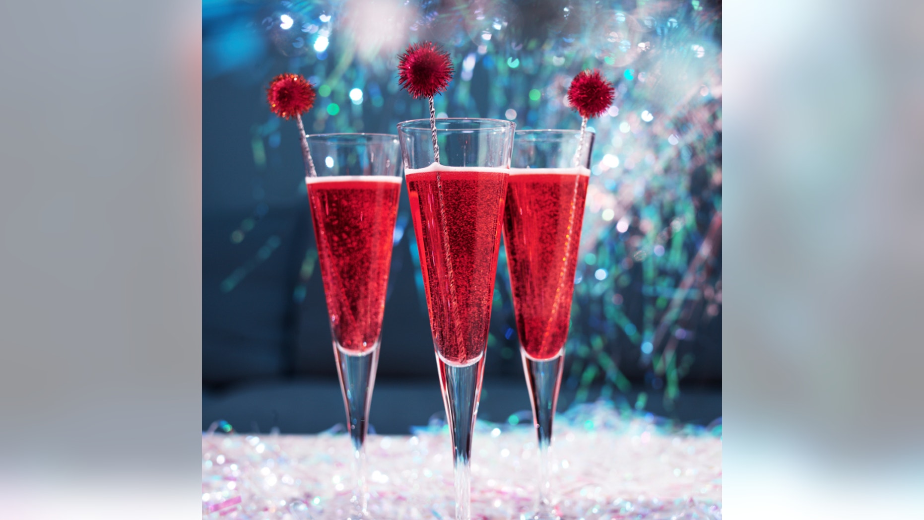 Champagne cocktails with tinsel and glitter in a festive party setting.f