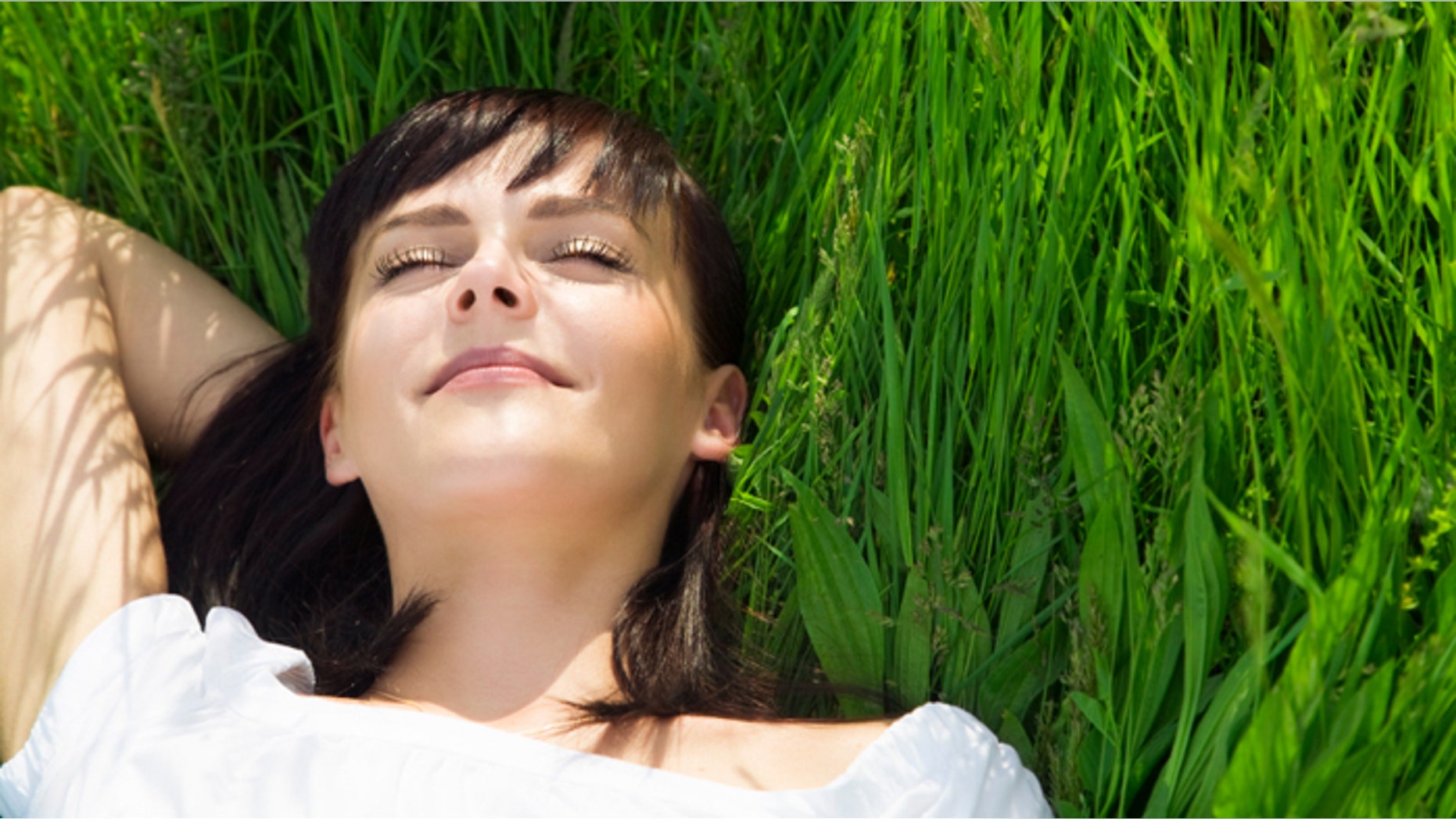 beautiful girl lying down of grass. Copy space