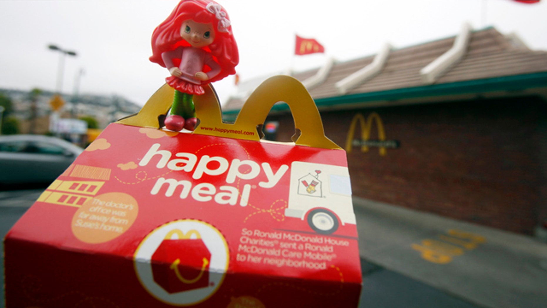 FILE - In this Oct. 1, 2010 file photo, a Happy Meal box and toy are shown outside of a McDonald's restaurant in San Francisco. City lawmakers on Tuesday, Nov. 2, 2010, approved legislation that they hope will force fast-food chains such as McDonald's to make their children's meals healthier or stop selling them with toys. (AP Photo/Jeff Chiu, File)