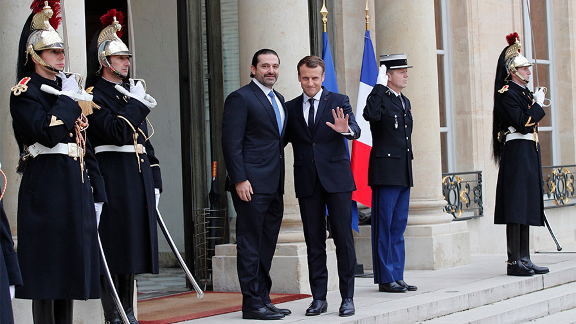 French President Emmanuel Macron, right, greets Lebanon's Prime Minister Saad Hariri upon his arrival at the Elysee Palace in Paris, Saturday