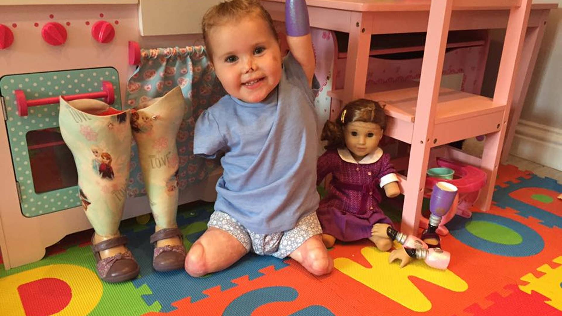 Harmonie poses with her new doll.