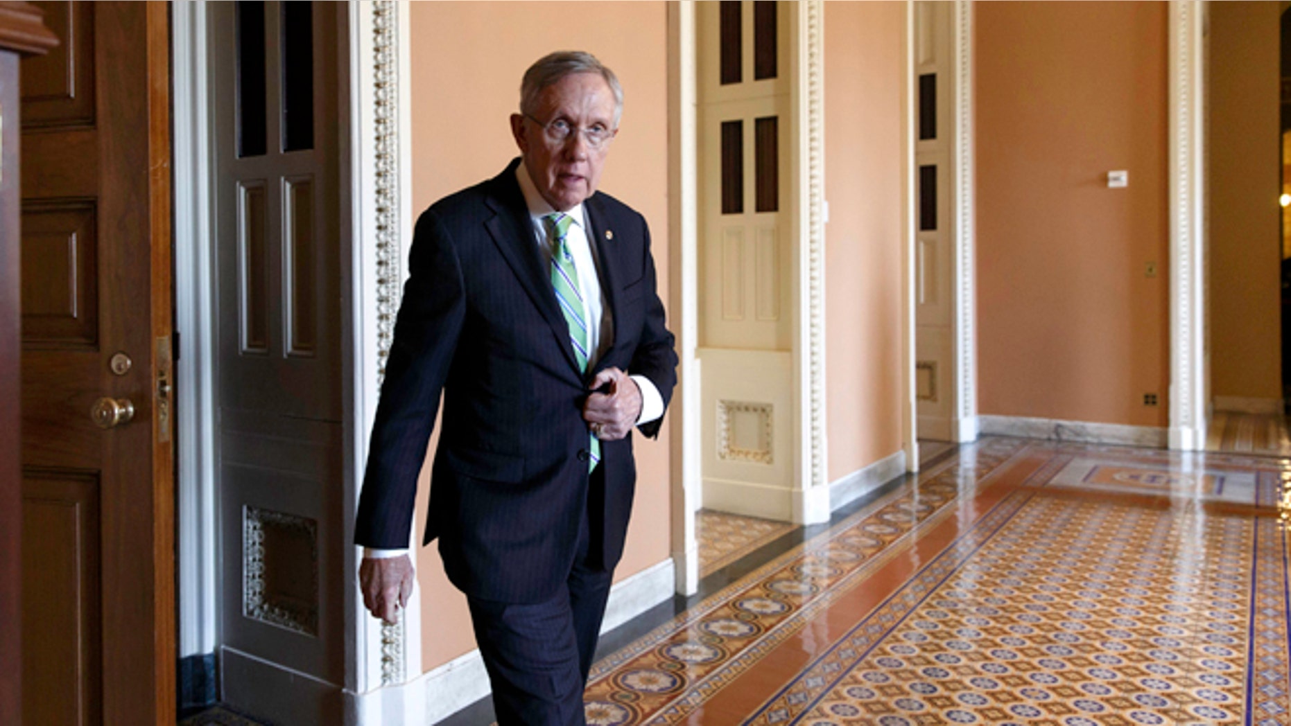 June 24, 2014: Senate Majority Leader Harry Reid of Nevada heads to speak to reporters on Capitol Hill in Washington.
