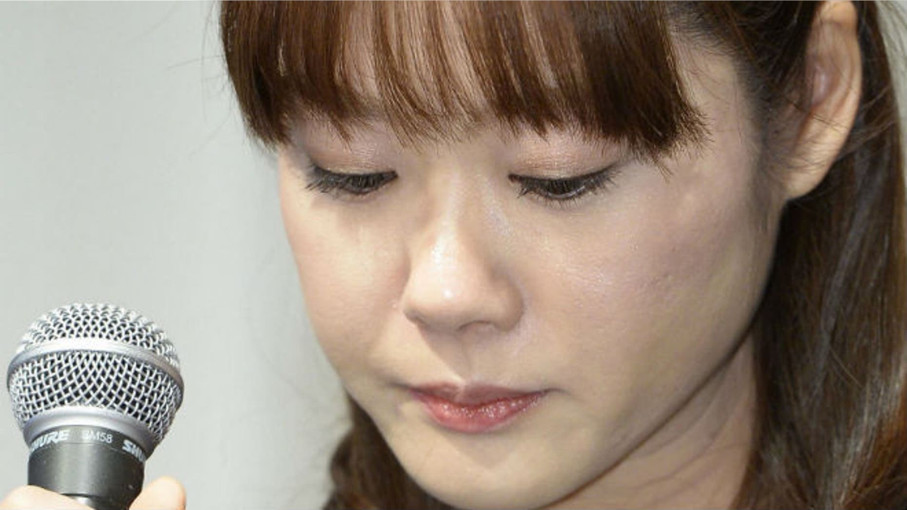 Haruko Obokata, a researcher at semi-governmental research institute RIKEN, lowers her eyes during a news conference in Osaka, western Japan, in this photo taken by Kyodo April 9, 2014. REUTERS/Kyodo