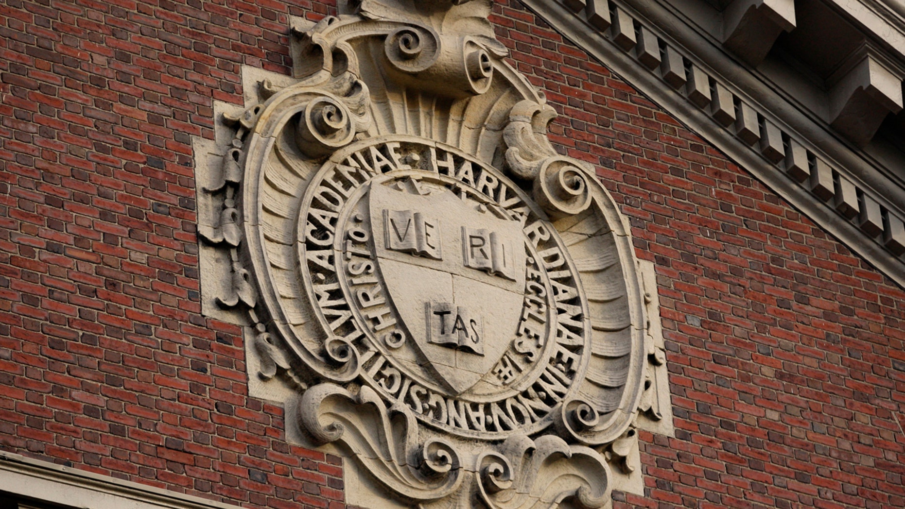 The university seal hangs over a building at Harvard University in Cambridge, Massachusetts, Nov. 16, 2012.