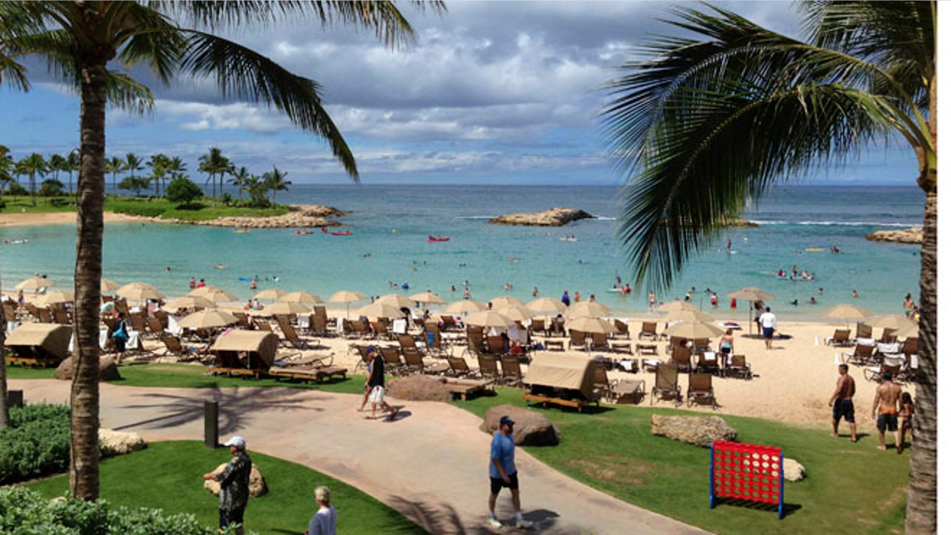 July 29, 2013: Tourists and locals play on Ko'Olina beach on the island of Oahu, Hawaii.