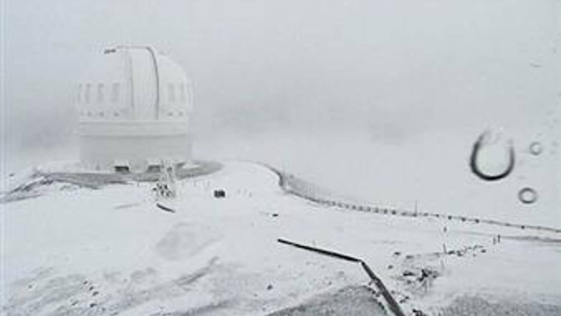 This webcam image shows the CFHT telescope on the summit of Mauna Kea on Hawaii's Big Island covered in snow on Dec. 1, 2016.