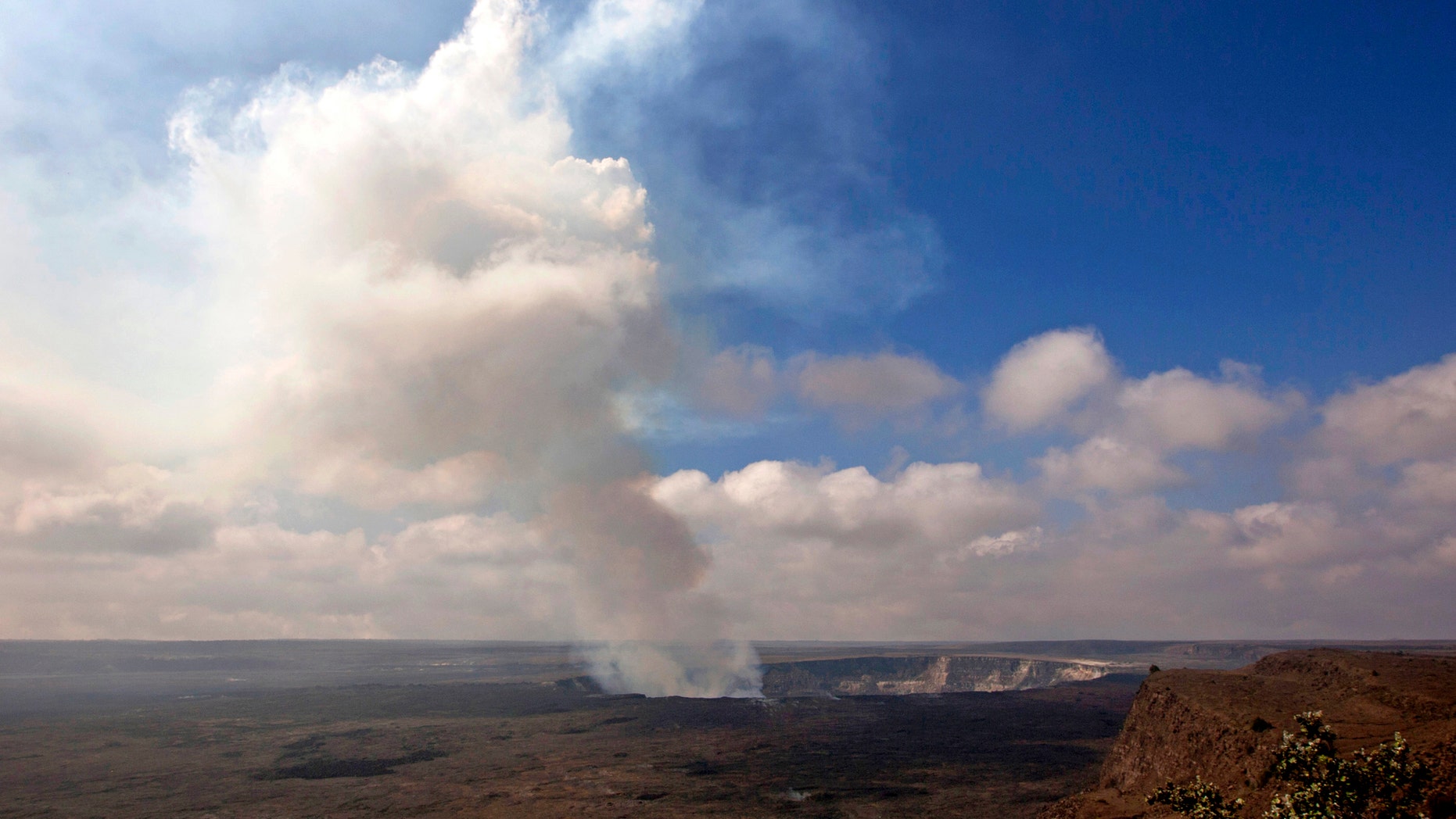 Sept. 1, 2015 photo of volcanic gas rising from the lava lake in Kilauea's Halemaumau Crater (AP Photo/Caleb Jones)