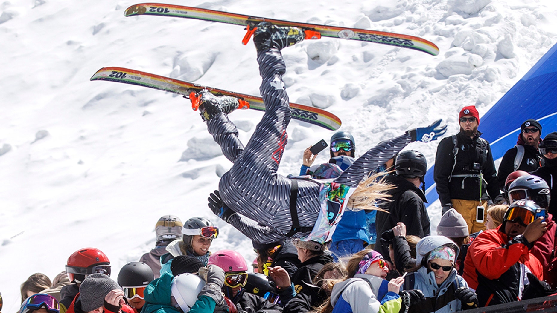 A participant of the Red Bull Slopesoakers Pond Skimming competition, Hayden Wright, 26, flies crowd from the jump during the event Saturday, April 14, 2018 at Copper Mountain, Colo. The crash resulted a broken collarbone of a women spectator and several other injuries. (Hugh Carey/Summit Daily News via AP)