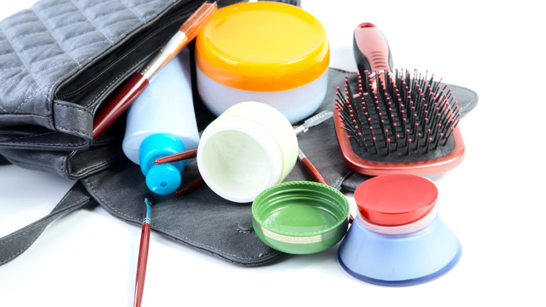 Female bag and cosmetics isolated on a white background