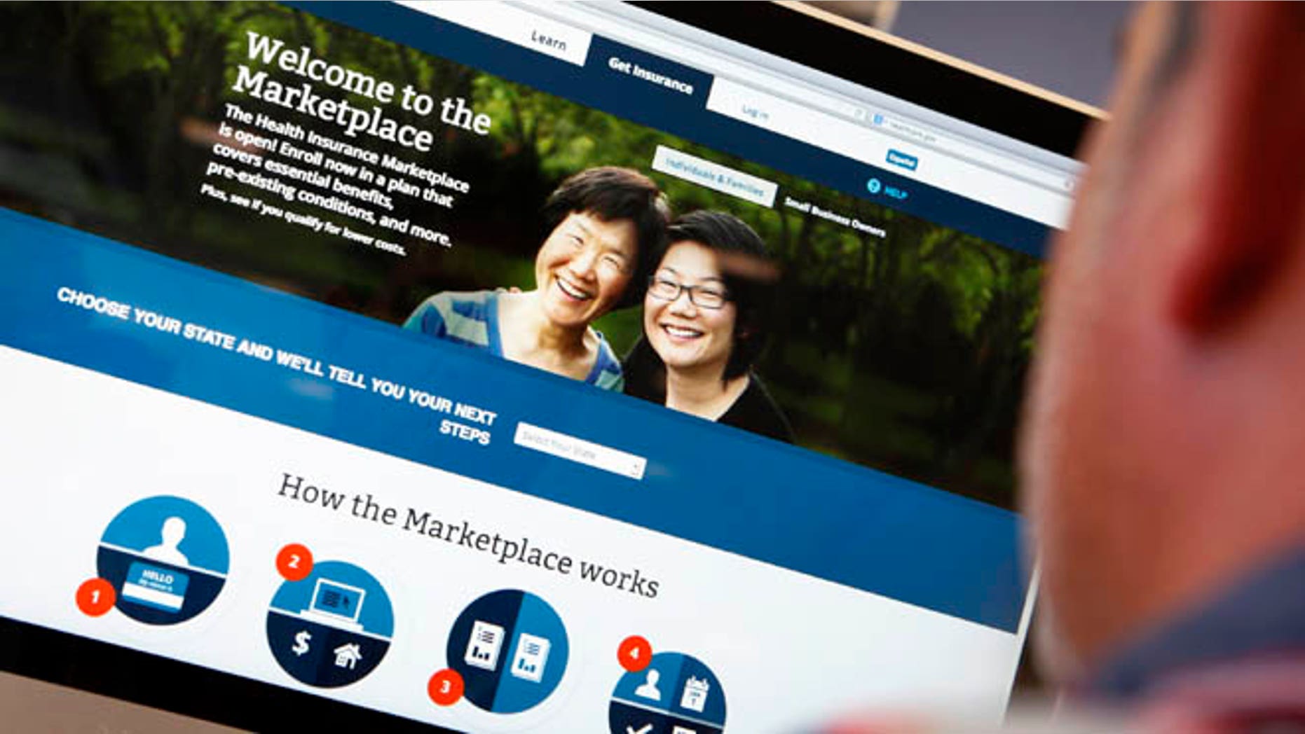 A man looks over the Affordable Care Act signup page on the HealthCare.gov website.