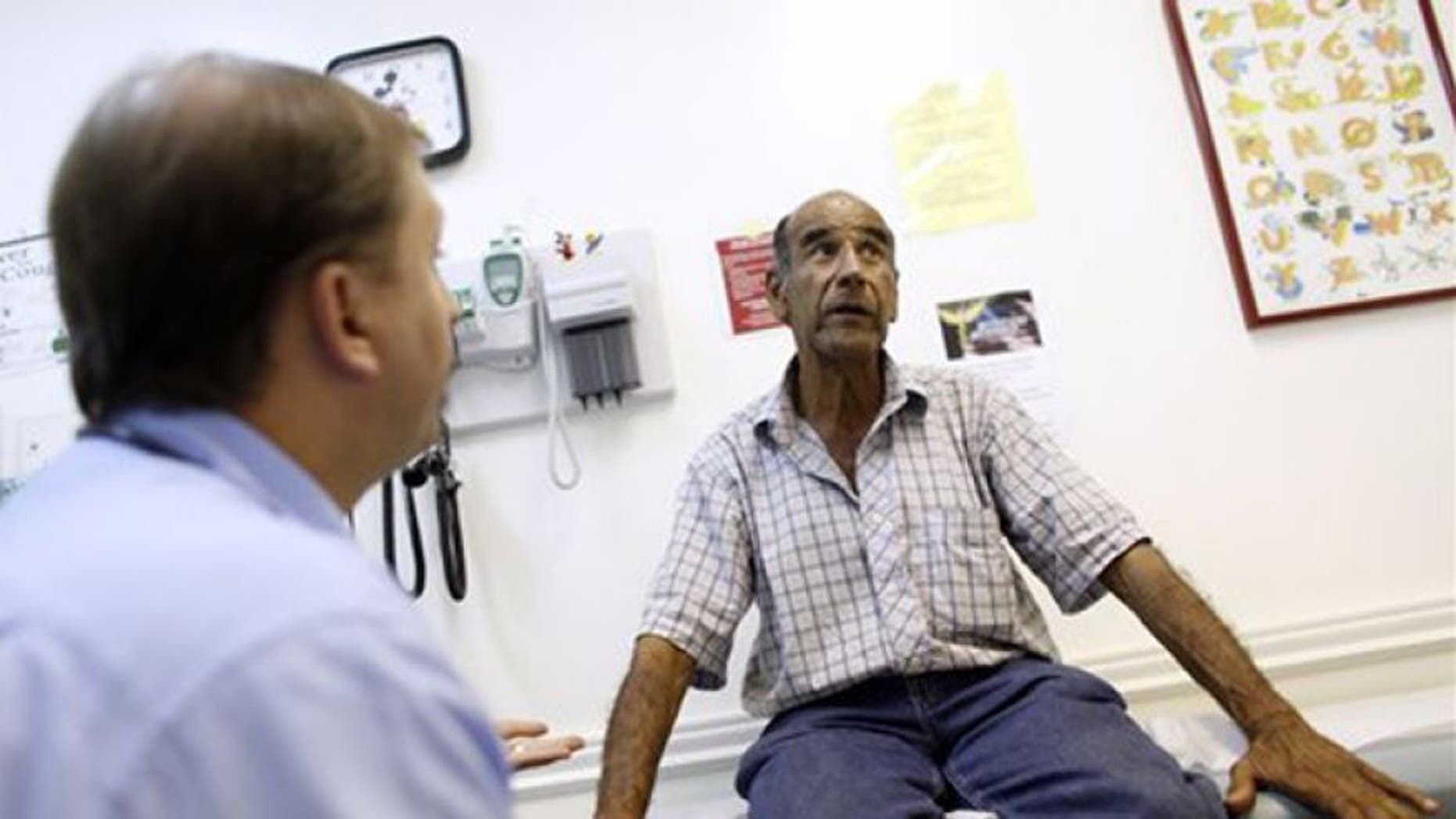 FILE: June 27, 2012: A patient talks with a doctor at Camillus Health Concern, in Miami.