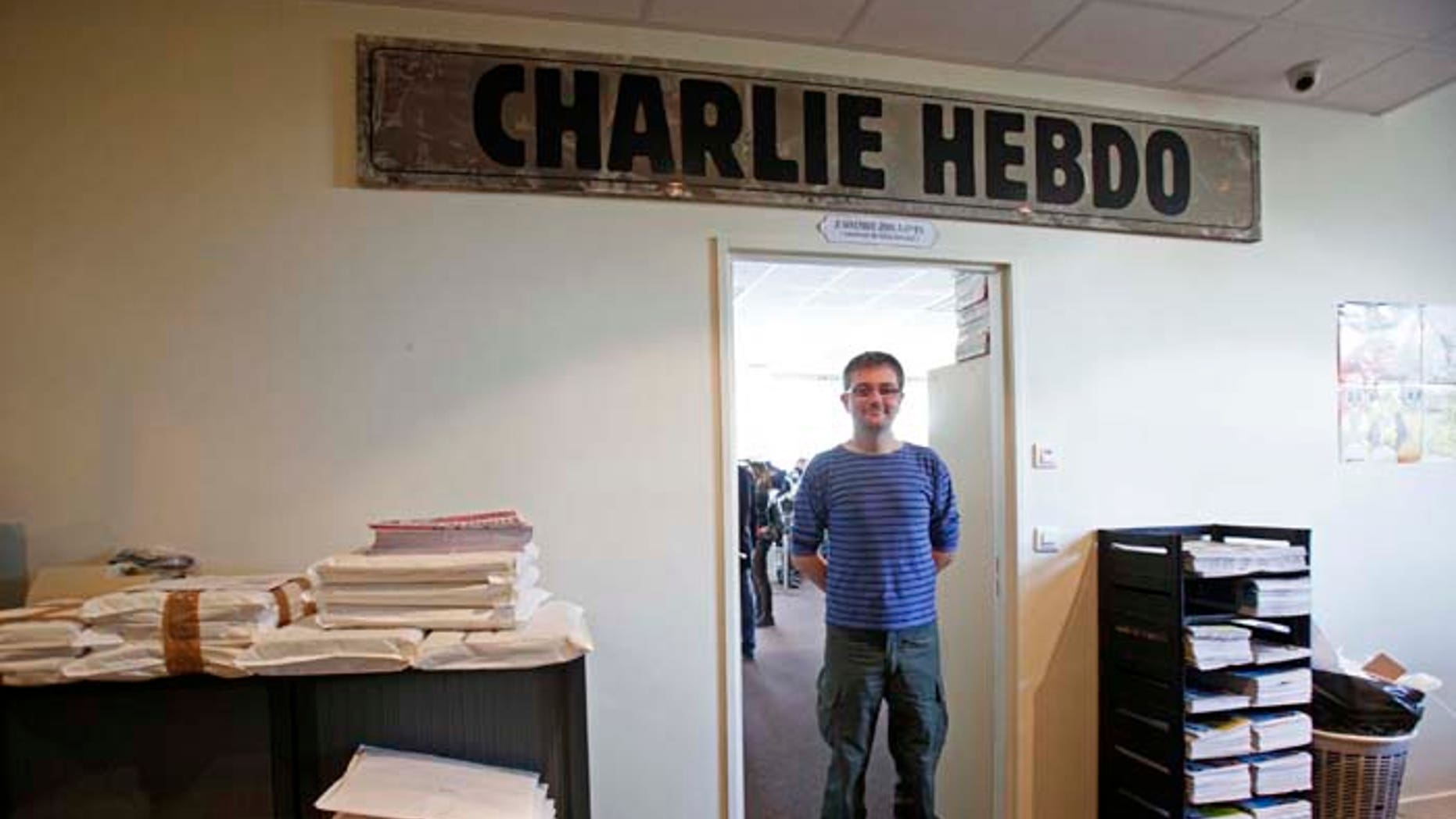 French cartoonist Charb, publishing director of French satirical weekly Charlie Hebdo, poses for photographs at their offices in Paris, September 19, 2012. Charlie Hebdo published cartoons of the Prophet Mohammad on Wednesday, a decision criticised by the French authorities which sent riot police to protect the magazine's offices. REUTERS/Jacky Naegelen (FRANCE - Tags: MEDIA CIVIL UNREST POLITICS RELIGION TPX IMAGES OF THE DAY) - RTR3853H