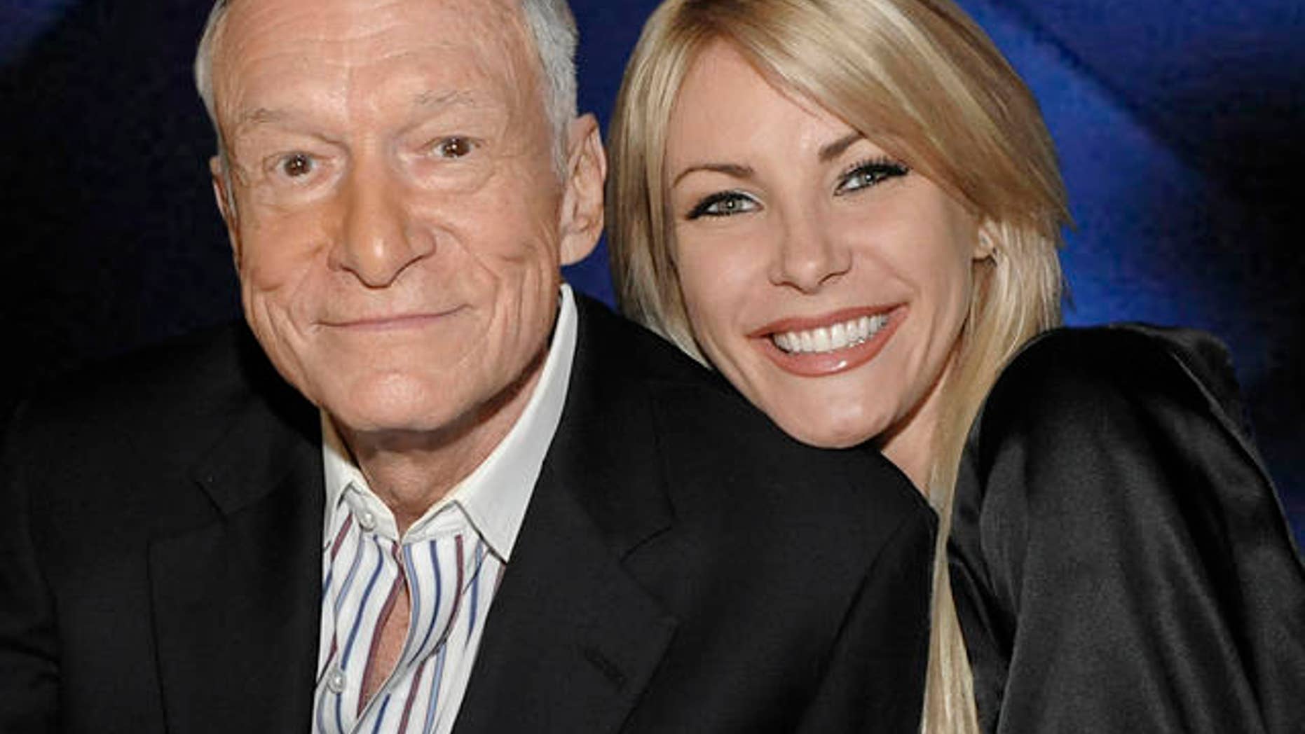 Hugh Hefner, left, and model Crystal Harris at a party celebrating the release of the book "Hugh Hefner's Playboy" a limited edition anthology by Taschen in Beverly Hills, Calif. on Thursday, Dec. 10, 2009. (AP Photo/Dan Steinberg)