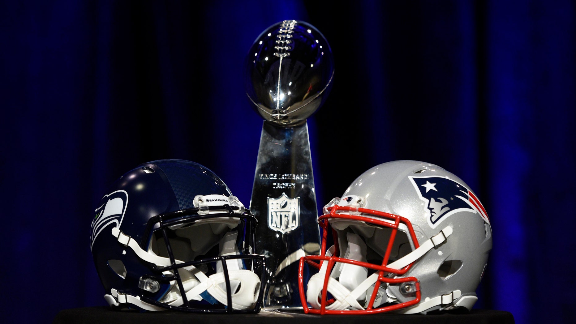 Jan 30, 2015: General view of the Vince Lombardi Trophy and helmets for the Seattle Seahawks and New England Patriots during a press conference for Super Bowl XLIX at Phoenix Convention Center.