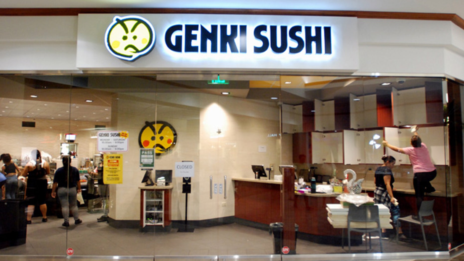 Employees clean the Genki Sushi conveyor belt restaurant chain Tuesday, Aug. 16, 2016, in Aiea, Hawaii.