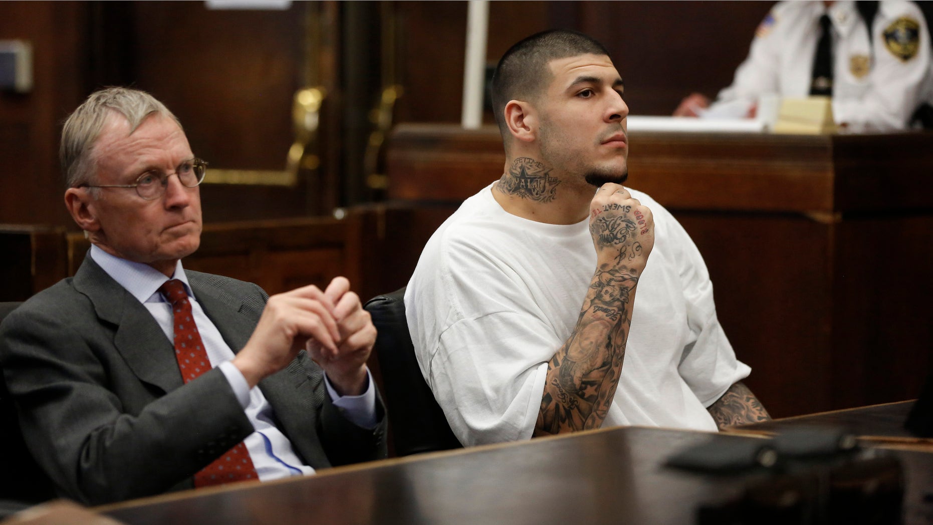Former New England Patriots NFL football player Aaron Hernandez, center, sits with defense attorney Charles Rankin, left, while attending a pre-trial hearing at Suffolk Superior Court, Tuesday, Dec. 22, 2015, in Boston. Hernandez is charged with killing two Boston men in 2012 after a chance encounter at a nightclub. (AP Photo/Steven Senne, Pool)