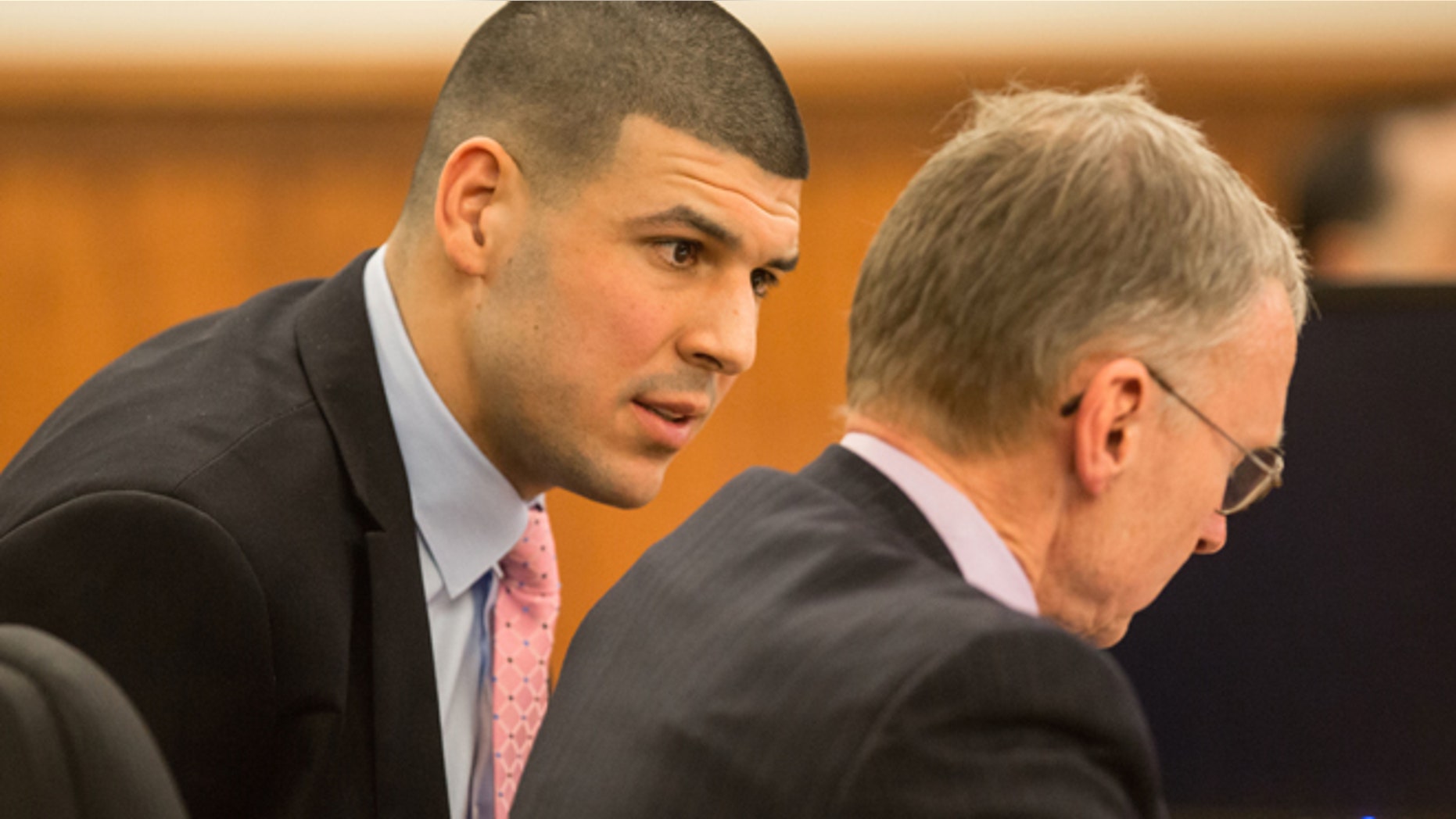 March 2: Former New England Patriots tight end Aaron Hernandez, left, speaks with his attorney Charles Rankin during his murder trial at Bristol County Superior Court in Fall River, Mass.