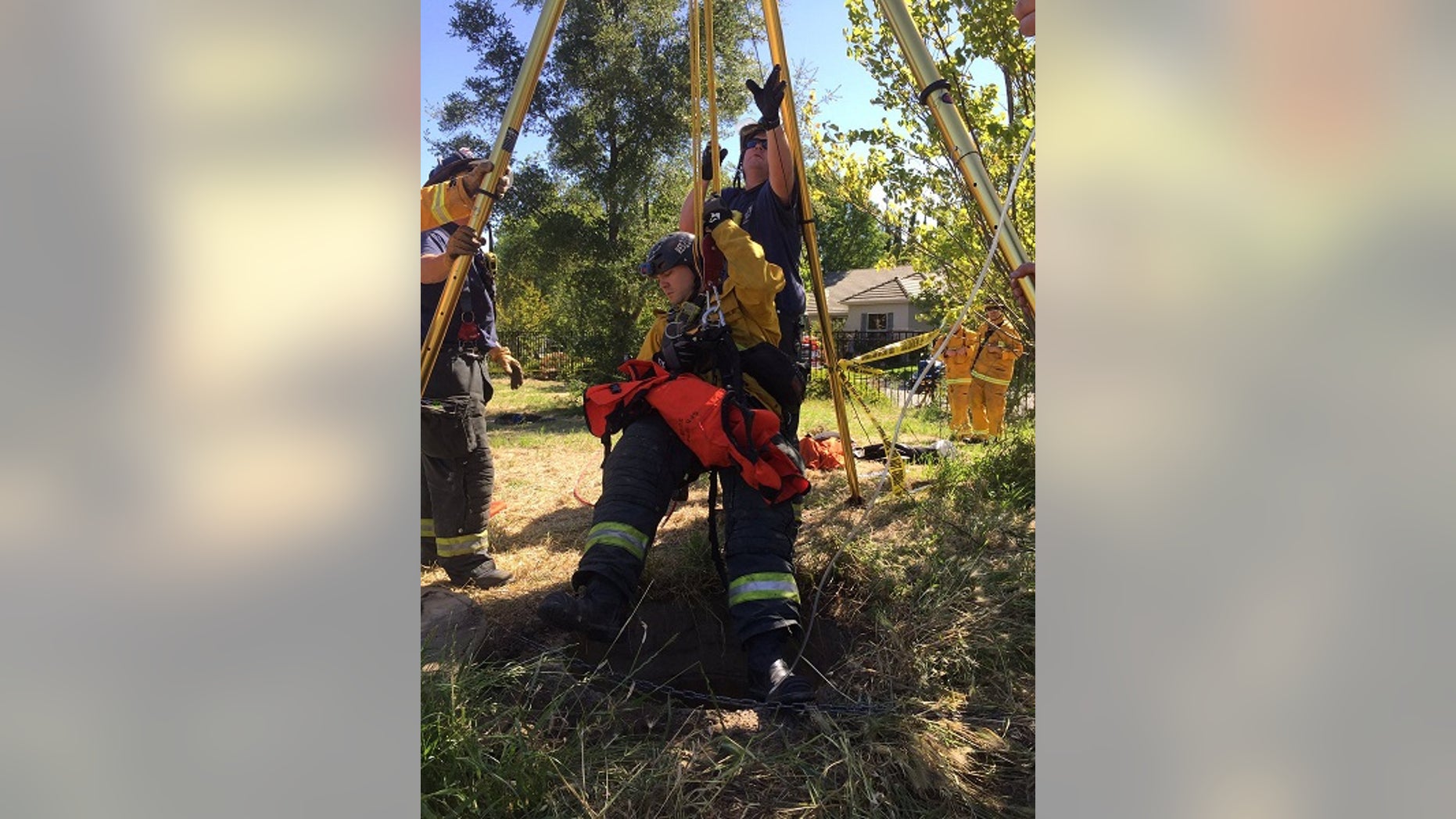 Rescuers being lowered into the drain on May 1.