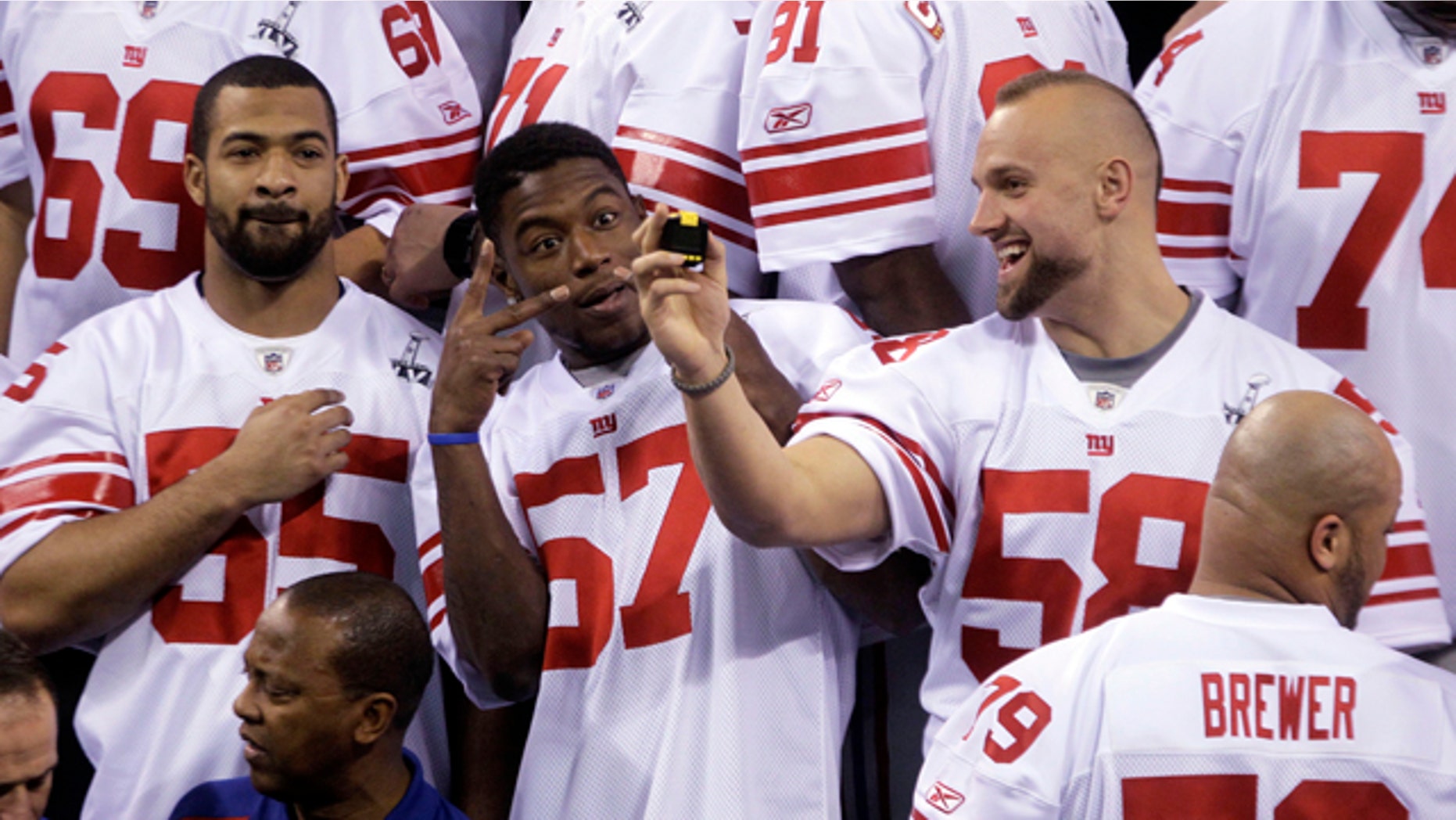 Jan. 31, 2012: New York Giants linebacker Spencer Paysinger (55), Jacquian Williams (57) and Mark Herzlich (58) have some fun during Media Day for NFL football's Super Bowl XLVI in Indianapolis.