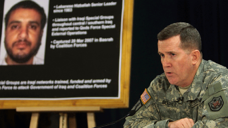 July 2, 2007: FILE - U.S. military spokesman Brig. Gen. Kevin J. Bergner speaks during a press conference in Baghdad, Iraq, near a poster of a senior Lebanese Hezbollah operative Ali Mussa Daqduq.