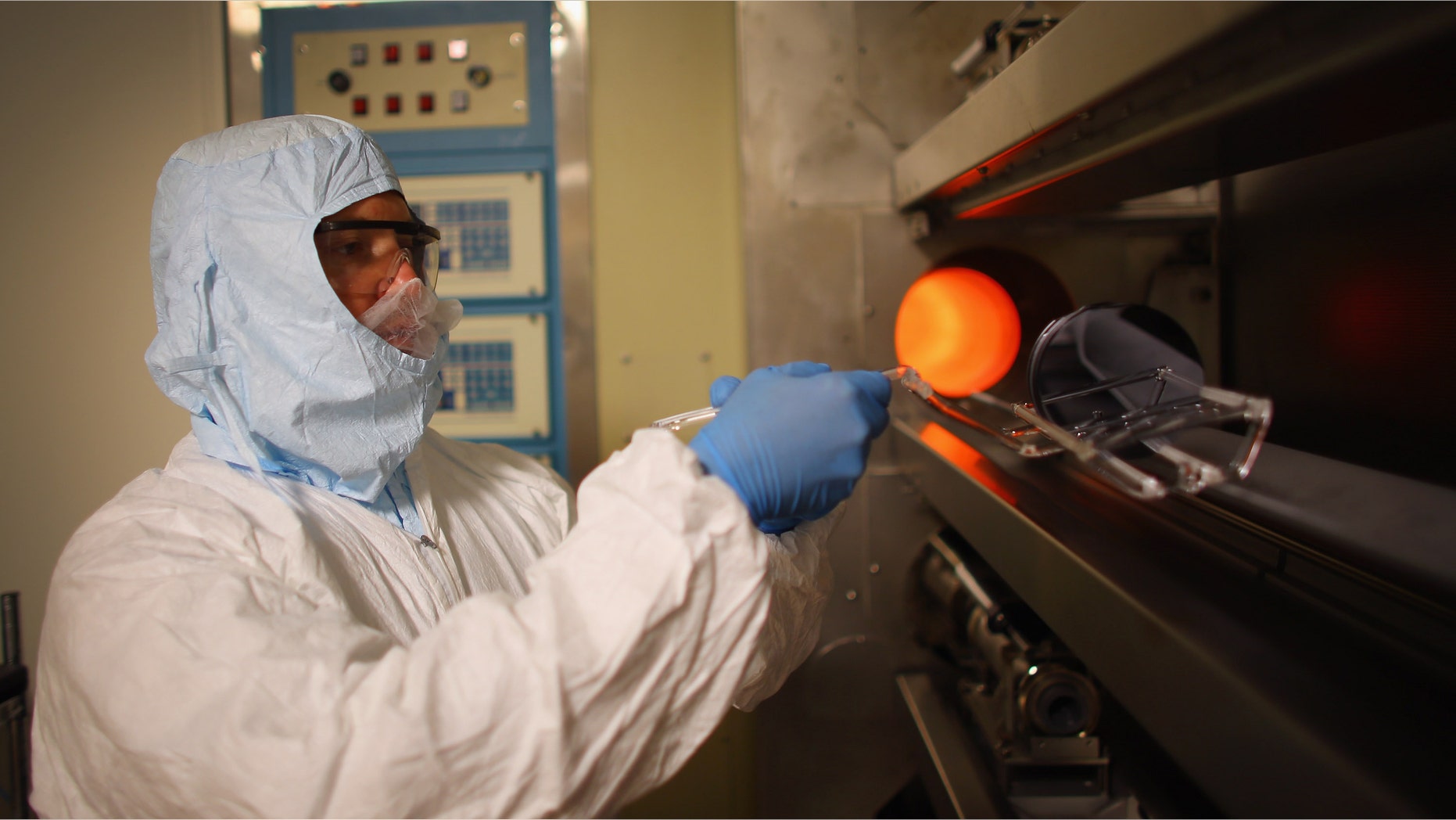TAMPA, FL - JULY 13: Richard Everly, a research engineer in the nanotechnology research and education center at the University of South Florida, handles silicon wafers in a diffusion furnace on July 13, 2012 in Tampa, Florida. Tampa has opportunities for employers and employees in such high tech industry as agritechnology, aerospace, digital media, energy technologies, life sciences and medical technologies. The city will host the 2012 Republican National Convention at the Tampa Bay Times Forum August 27-30 where the party is expected to officially nominate former Massachusetts Gov. Mitt Romney as their nominee to face President Barack Obama in November in the general election. The convention will host 2,286 delegates and 2,125 alternate delegates from all 50 states, the District of Columbia and five territories as well as scores of journalists, guests and protesters. (Photo by Joe Raedle/Getty Images)