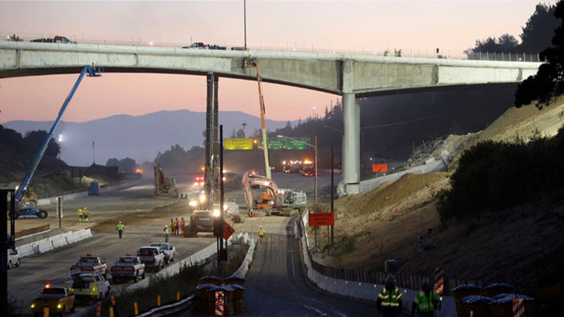 FILE: 2011: Workers demolish the Mulholland Drive bridge across the 405 freeway in Los Angeles, Calif.