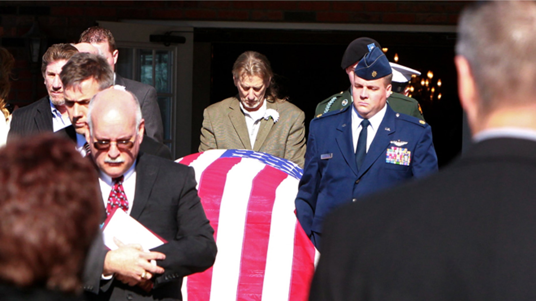 Pallbearers carry the coffin containing the body of David Decareaux to a hearse after funeral services in Waterloo, Ill. Decareaux and two of sons, Grant, 8, and Dominic, 10, died last week from cold while hiking along the Ozark Trail.