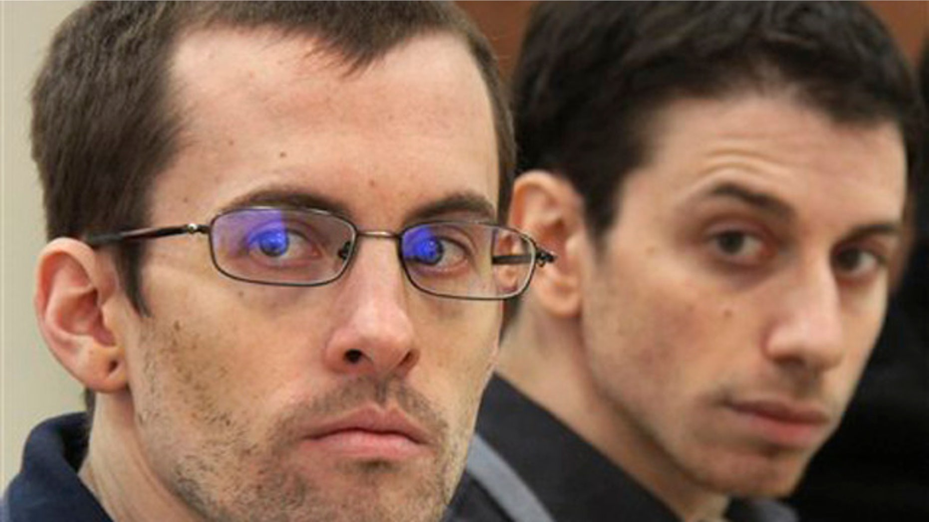In this Sunday, Feb. 6, 2011 file photo, US hikers Shane Bauer, left, and Josh Fattal, attend their trail in Iran.