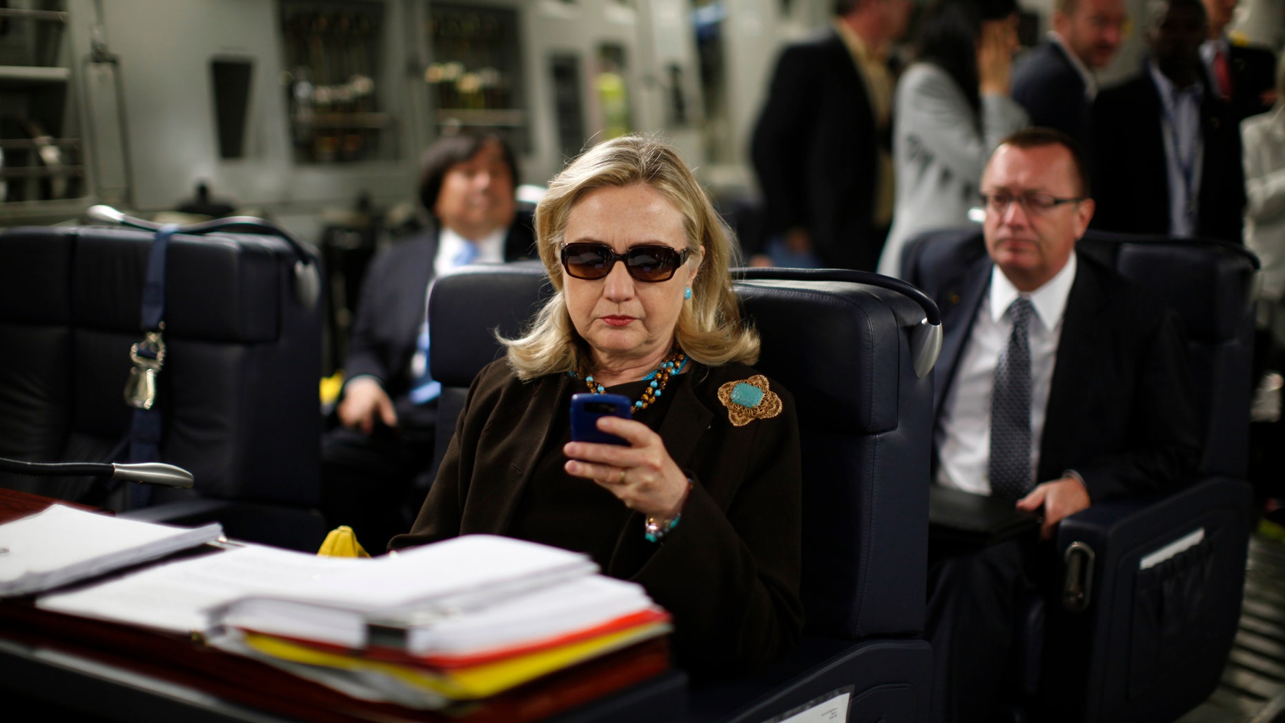 U.S. Secretary of State Hillary Rodham Clinton works from a desk inside a C-17 military plane upon her departure from Malta, in the Mediterranean Sea, bound for Tripoli, Libya, Tuesday Oct.18, 2011.