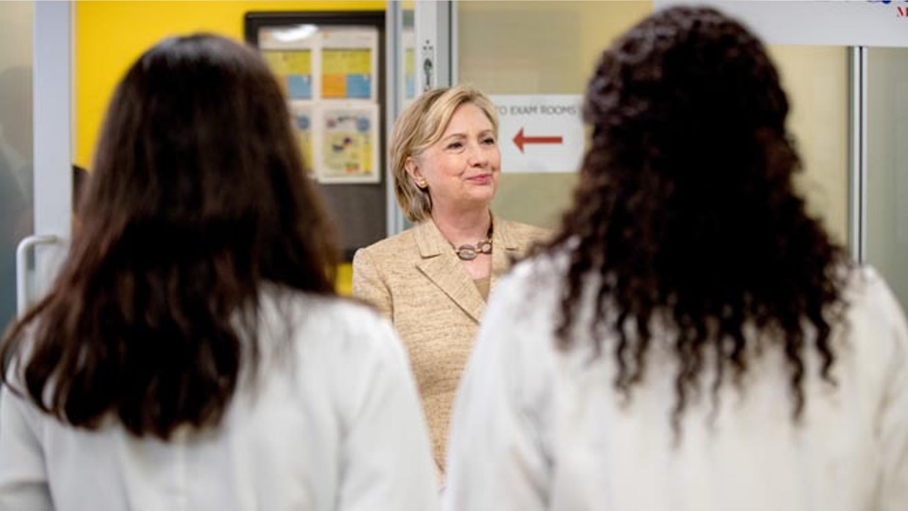 Democratic presidential candidate Hillary Clinton meets with doctors as she takes a tour of Borinquen Health Care Center, in Miami, Tuesday, Aug. 9, 2016, to see how they are combatting Zika. The center is within and serves the current area identified by the CDC where the Zika virus is being spread by mosquitos. (AP Photo/Andrew Harnik)