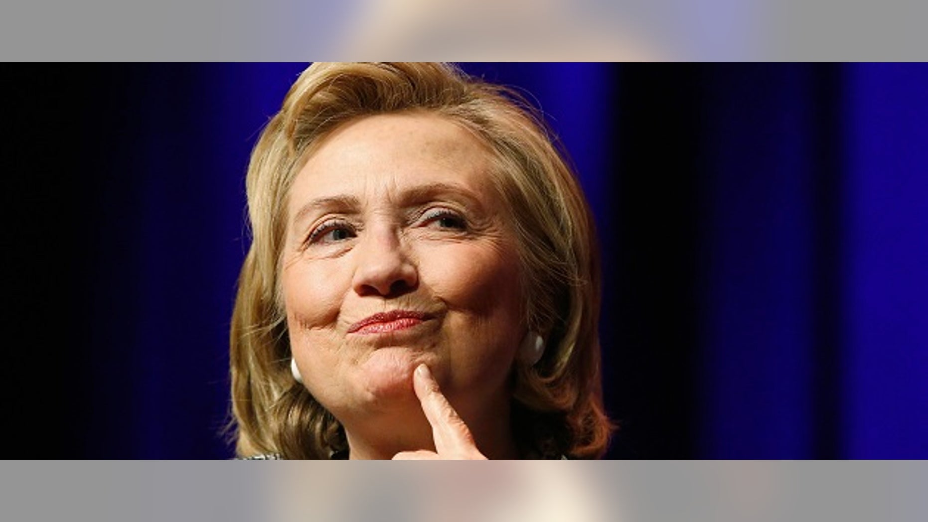 FILE -- June 13, 2014: Former Secretary of State Hillary Clinton reacts to a question as she discusses her book "Hard Choices: A Memoir" at George Washington University in Washington.
