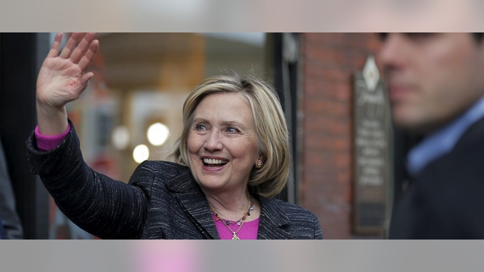 Democratic presidential candidate Hillary Clinton waves to supporters gathered outside after she spoke at the Water Street Bookstore in Exeter, New Hampshire May 22, 2015. REUTERS/Brian Snyder - RTX1E6EM