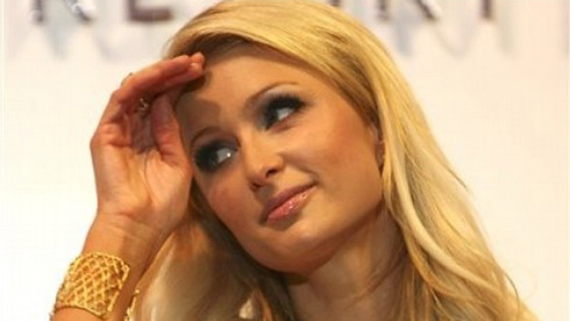 American heiress and media personality Paris Hilton strokes her hair during a news conference at the financial district of Makati city, east of Manila, Philippines, Wednesday, Aug. 17, 2011. Hilton is in Manila for a five-day visit to announce her partnership with a property and resort development company, inaugurate her own line of boutique and to meet her friend, Filipino world boxing champion Manny Pacquiao and wife Jinkee. (AP Photo/Bullit Marquez)