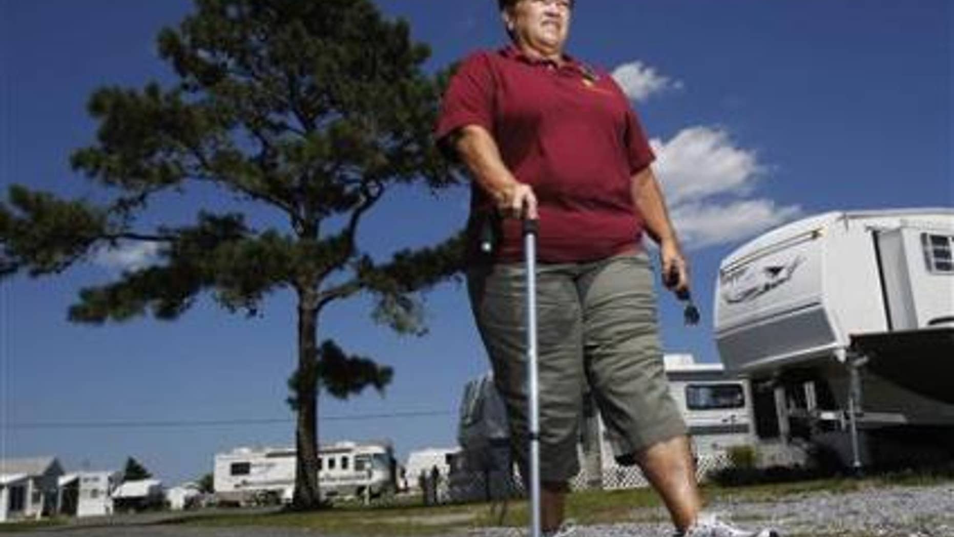 Harriet Bowen, who had hip replacement surgery, walks near her trailer at the Treasure Beach trailer park in Selbyville, Delaware, June 27, 2012. REUTERS/Tim Shaffer