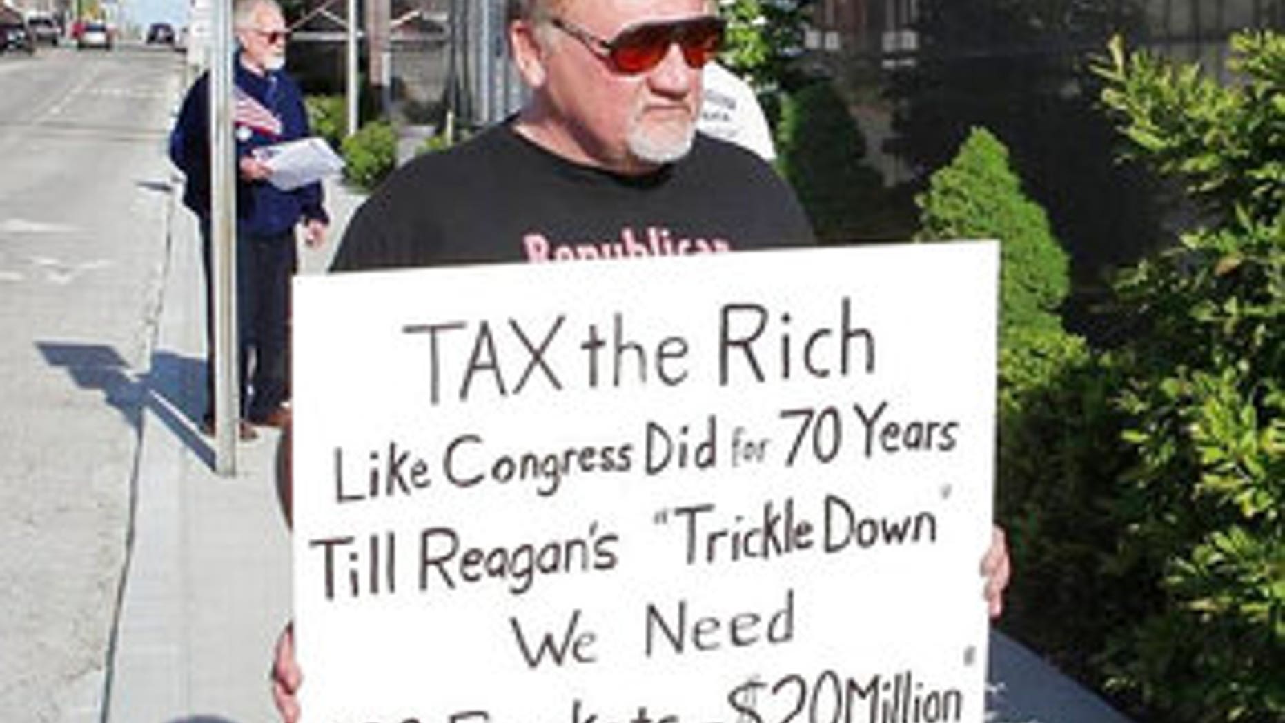 In this undated file photo, James Hodgkinson holds a sign during a protest outside of a United States Post Office in Belleville, Ill.