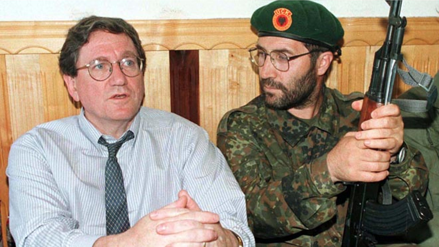 FILE 1998: Special U.S. envoy for the Balkans Richard Holbrooke, left, sits with an unidentified Kosovo Liberation Army soldier at their headquarters in Junik.