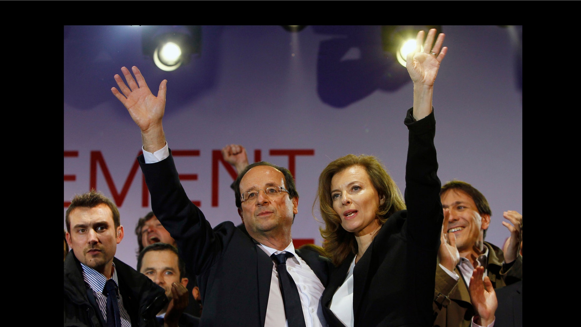French president-elect Francois Hollande, center left, wave to supporters with his companion Valerie Trierweiler after greeting crowds gathered to celebrate his election victory in Bastille Square in Paris.