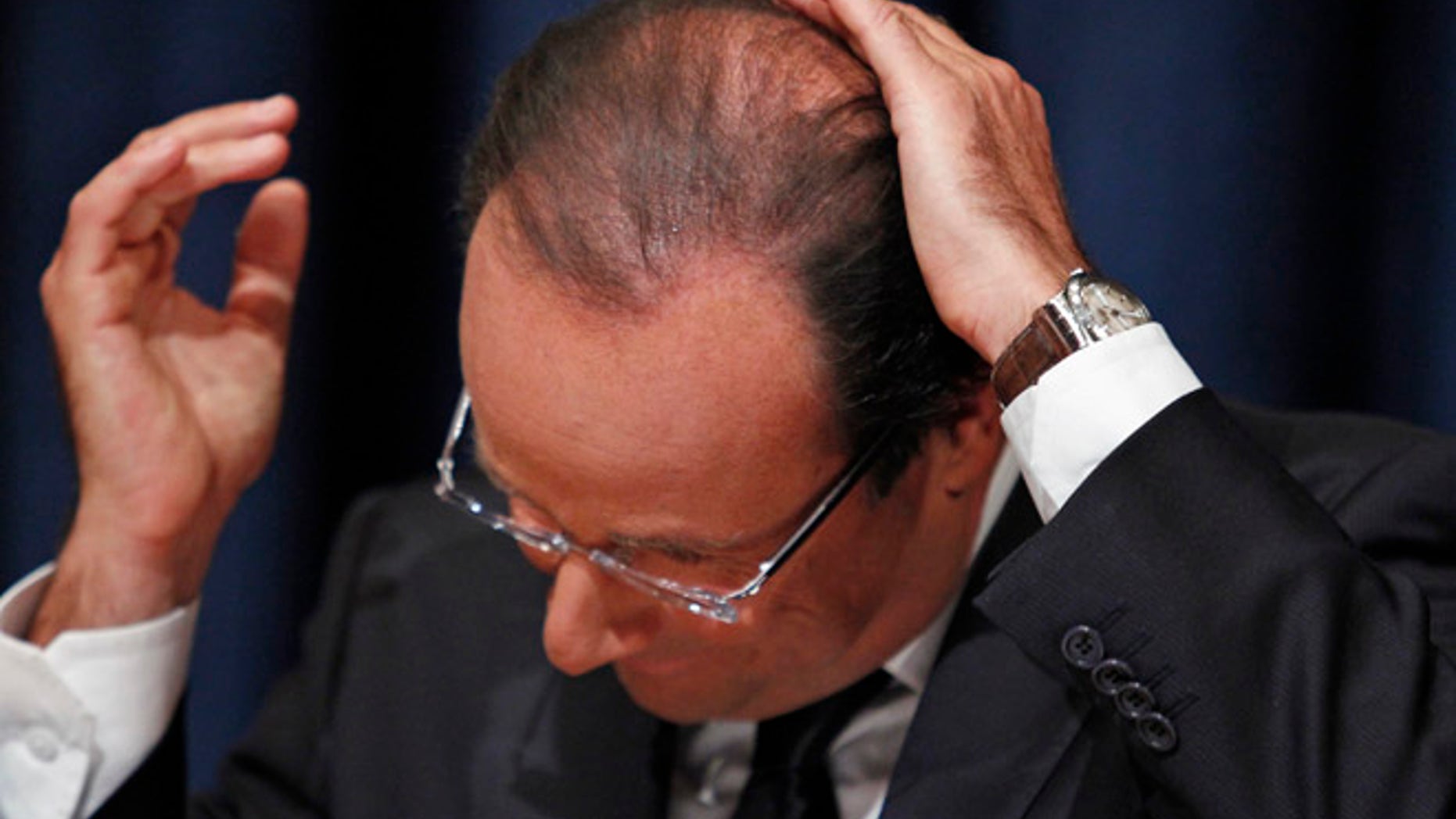 FILE: France's President Francois Hollande smoothes down his hair during a news conference in New York.