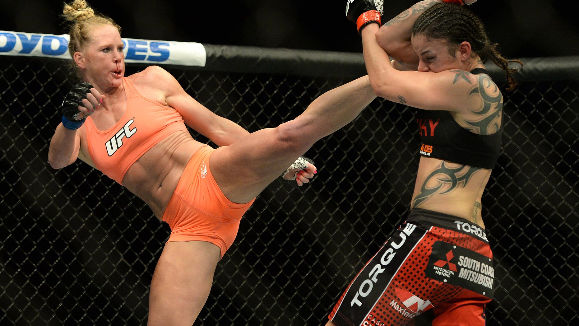 Feb 28, 2015; Los Angeles, CA, USA; Raquel Pennington (red gloves) and Holly Holm (blue gloves) during their women's bantamweight bout at UFC 184 at Staples Center. Mandatory Credit: Jayne Kamin-Oncea-USA TODAY Sports - RTR4RL8T